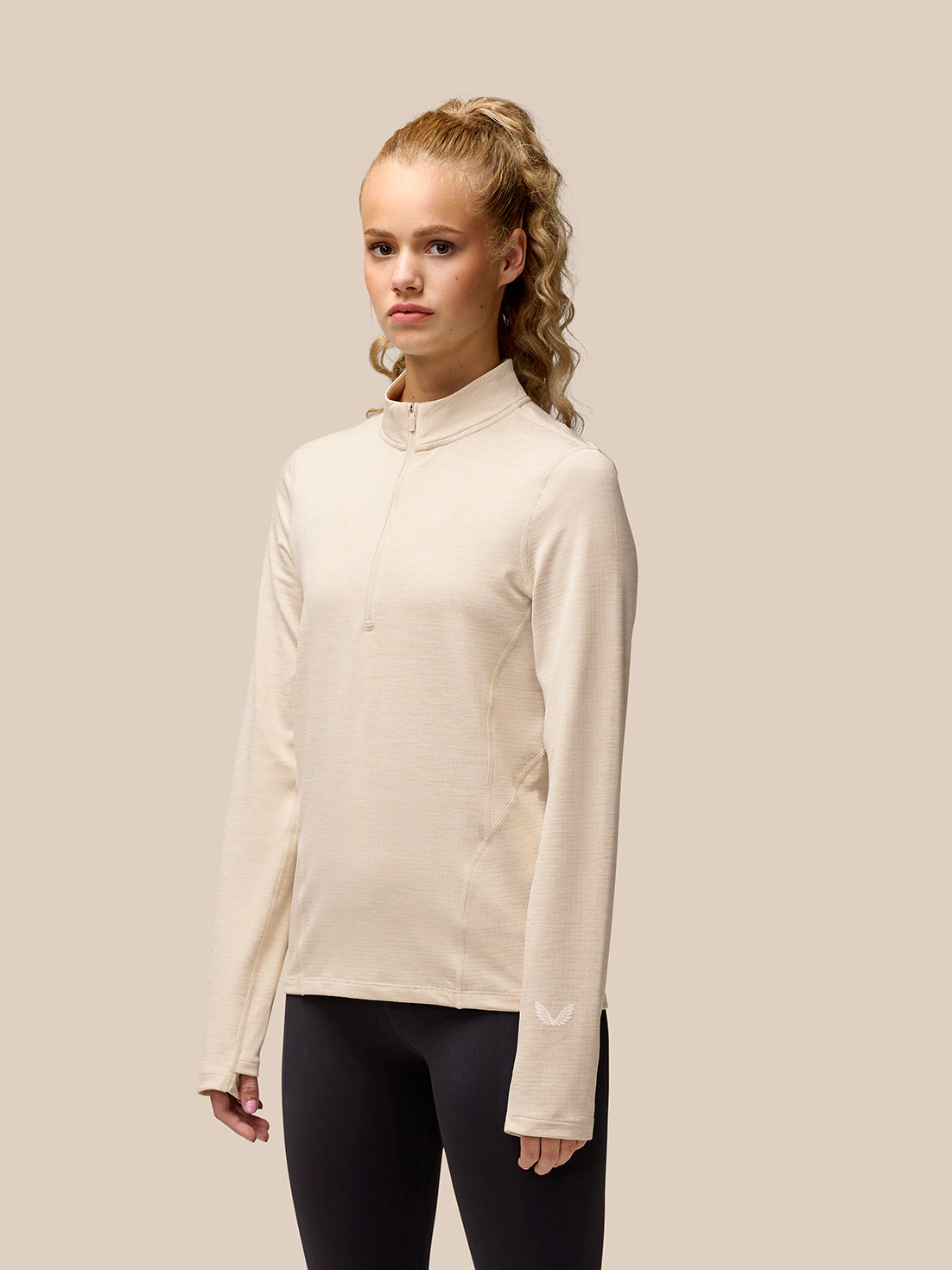 Beige Flow Training half zip fleece top worn by a model with funnel collar and front zip
