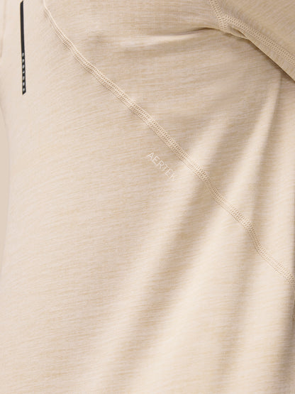 Close-up of beige Flow Training fabric showing AerTek branding along the seam.