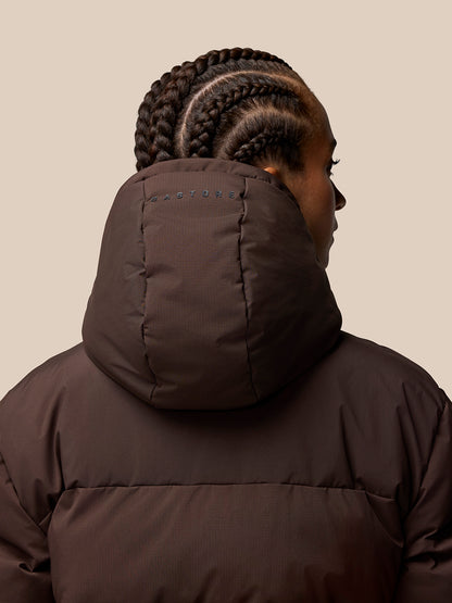 Back view of brown Quilts Lifestyle Jacket with insulated hood and Castore branding on the hood