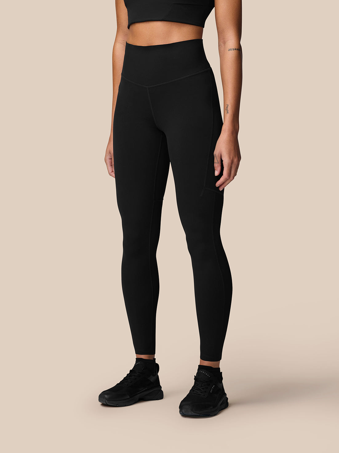 Back view of black Apex Training Leggings with high waist and reflective waistband detail