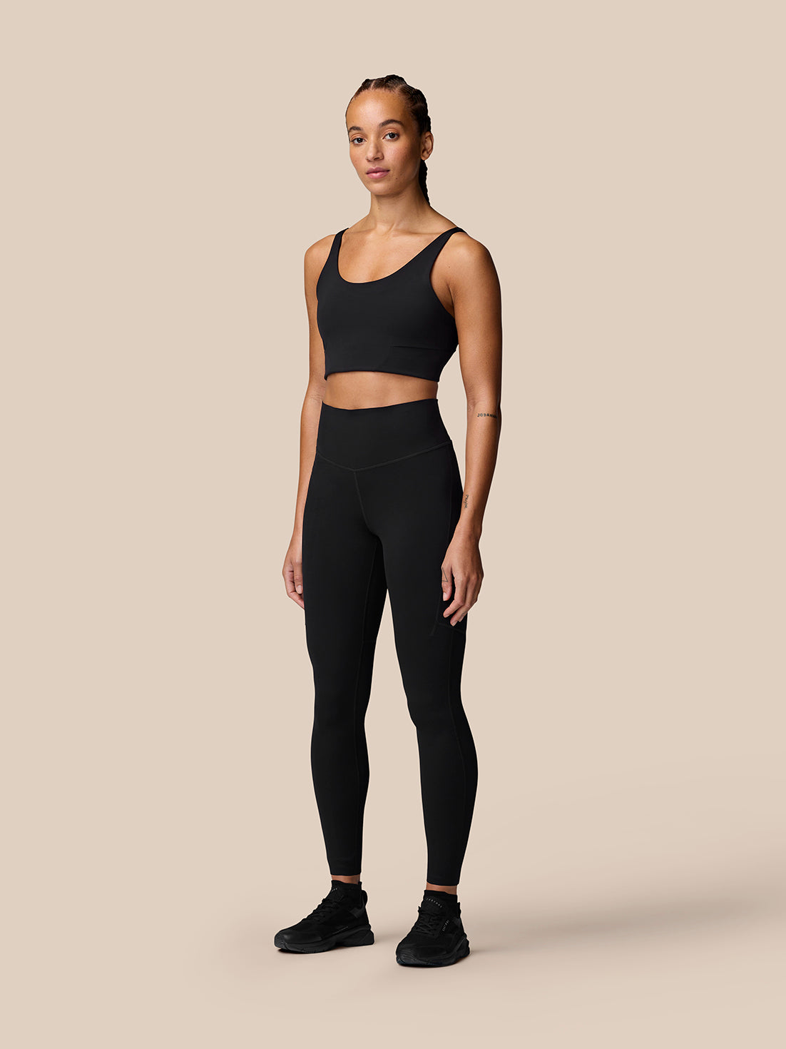 Model wearing black Apex Training Leggings with full length design and side panels