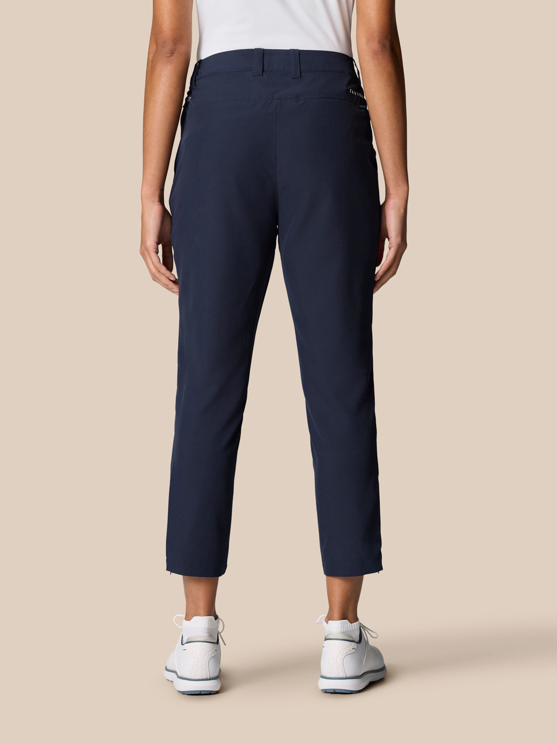 Back view of a model in midnight navy Golf Club Trousers 7/8 length.