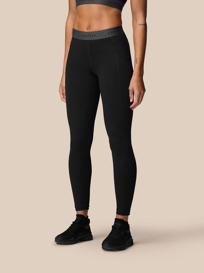 Model wearing black Adapt Training Leggings with a wide CASTORE waistband