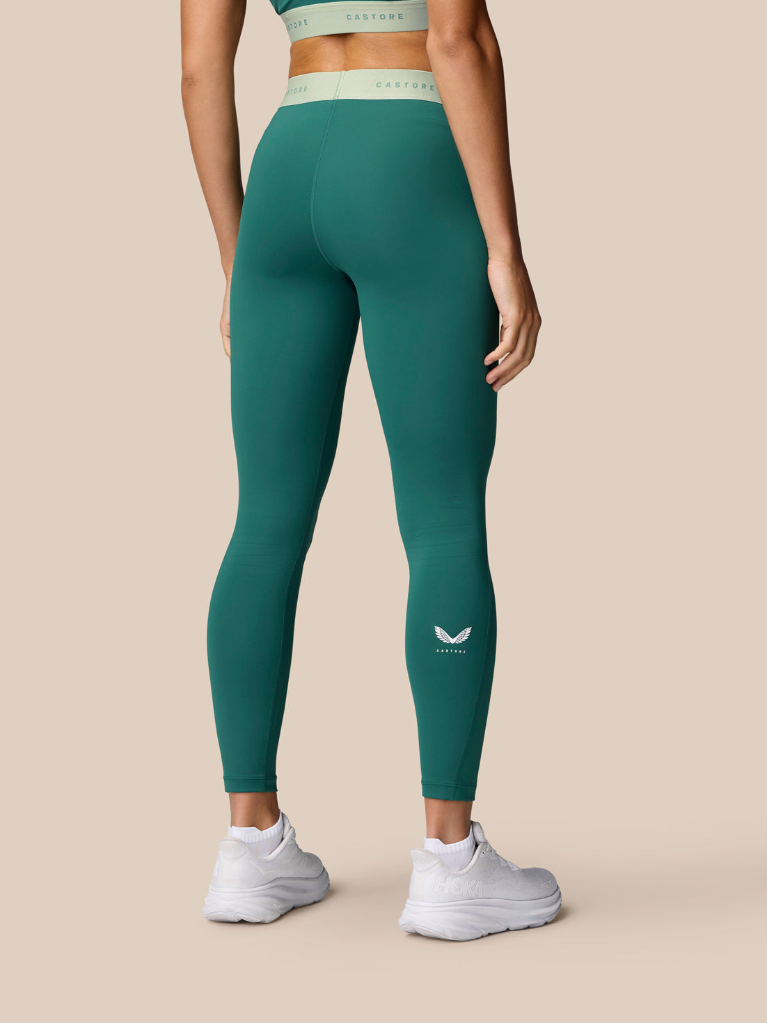 Adapt Training Leggings in seafoam shown from the back with mint waistband and a small logo on the calf.