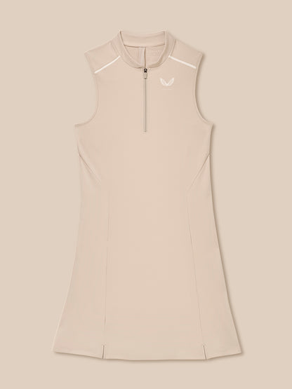 Pinnacle Dress in Stone front view on a model; sleeveless beige performance dress with a quarter zip and sleek paneling.