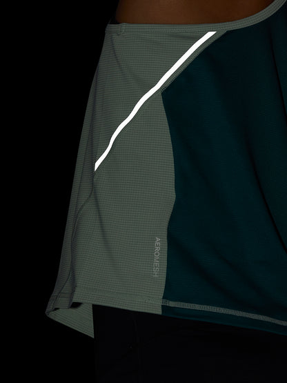 Close-up of side seam on Sage Apex Training Tank Top highlighting Aeromesh fabric and reflective trim