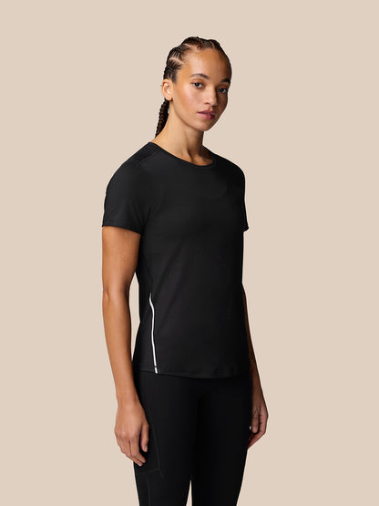 Model wearing Apex Training T-Shirt in black with reflective side seam and curved hem.