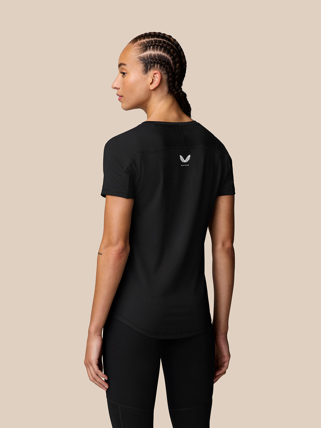 Back view of a model wearing black Apex Training T-Shirt with small logo on the upper back