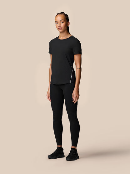 Full-body front view of a model in black Apex Training T-Shirt with reflective side stripe.