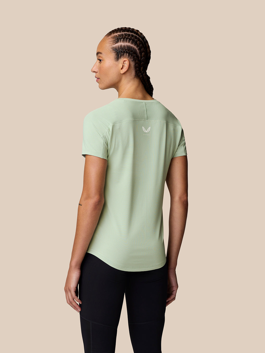 Back view of model wearing Sage Apex Training T-Shirt with reflective logo on the upper back