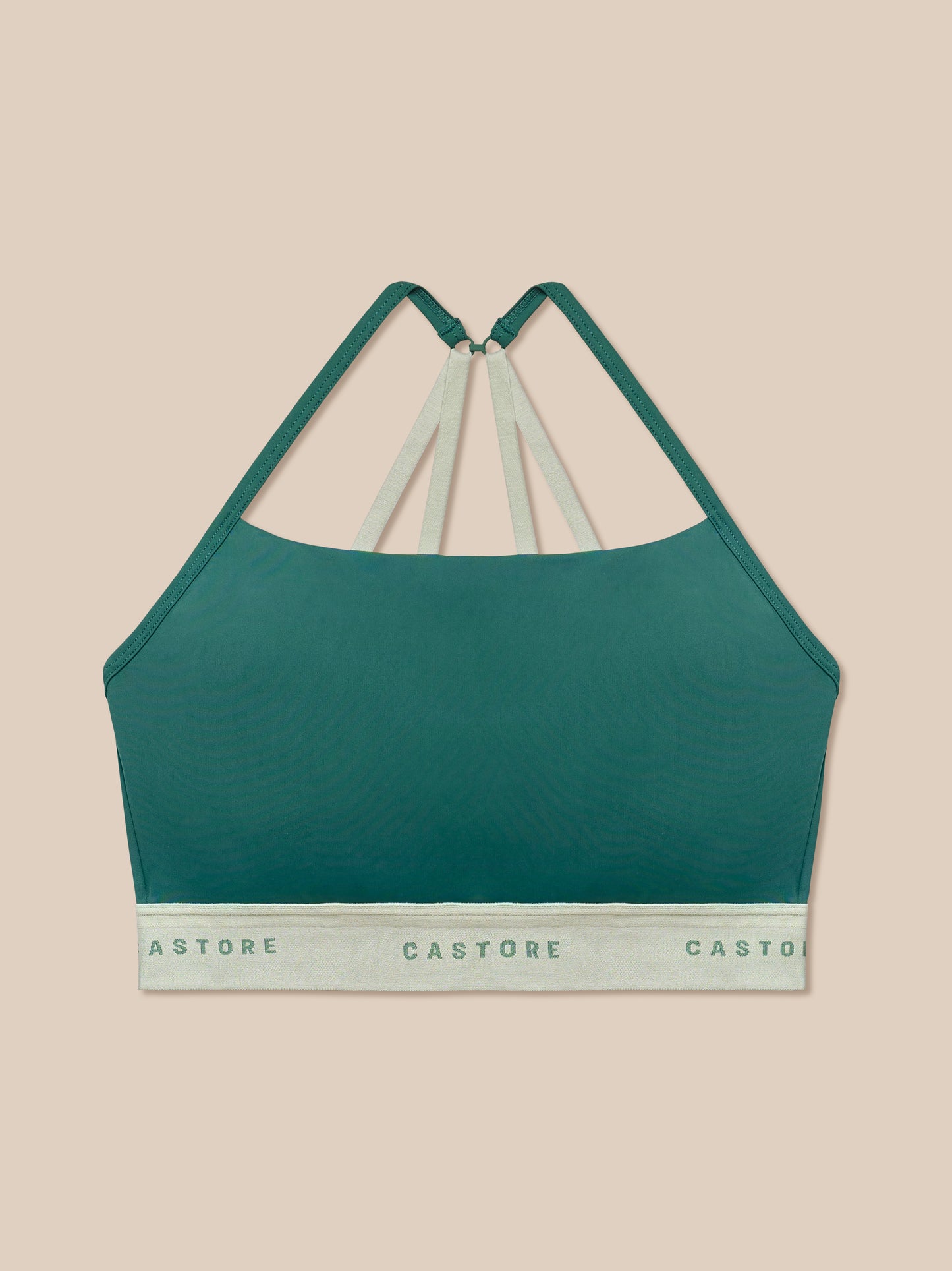Seafoam Adapt Training Sports Bra with beige back straps against a peach background.