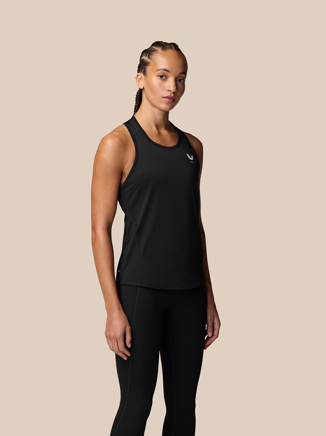 Model wearing black Adapt Training Tank Top with racerback for breathability and a dropped hem