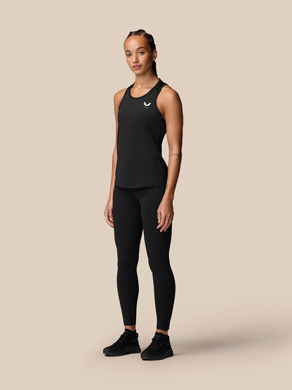 Full body shot of model wearing black Adapt Training Tank Top with racerback and black leggings