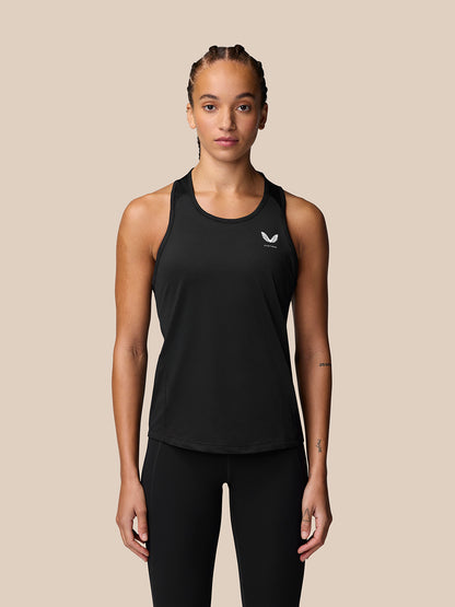 Female model wearing Adapt Training Tank Top in black with racerback and Castore logo on chest.