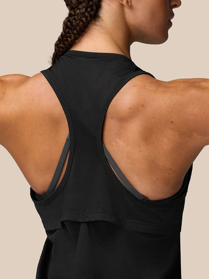 Back view of a woman wearing a black Adapt Training Tank Top with a racerback and contrasting grey straps