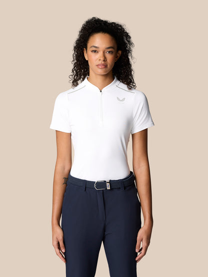 Woman wearing white Pinnacle Polo with zip placket and left chest logo, paired with navy pants.