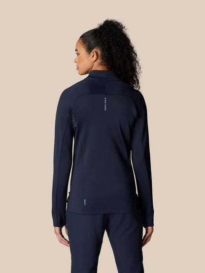 Back view of a model in Midnight Navy Pinnacle LVS ½ Zip Top showing back panels and logo details.