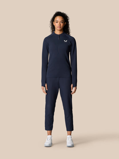 Woman wearing Midnight Navy Golf Pinnacle LVS ½ Zip Top with long sleeves and front half zip.