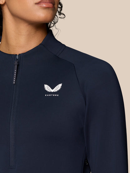 Front close up of navy Pinnacle LVS half zip top with chest logo and zipper detail