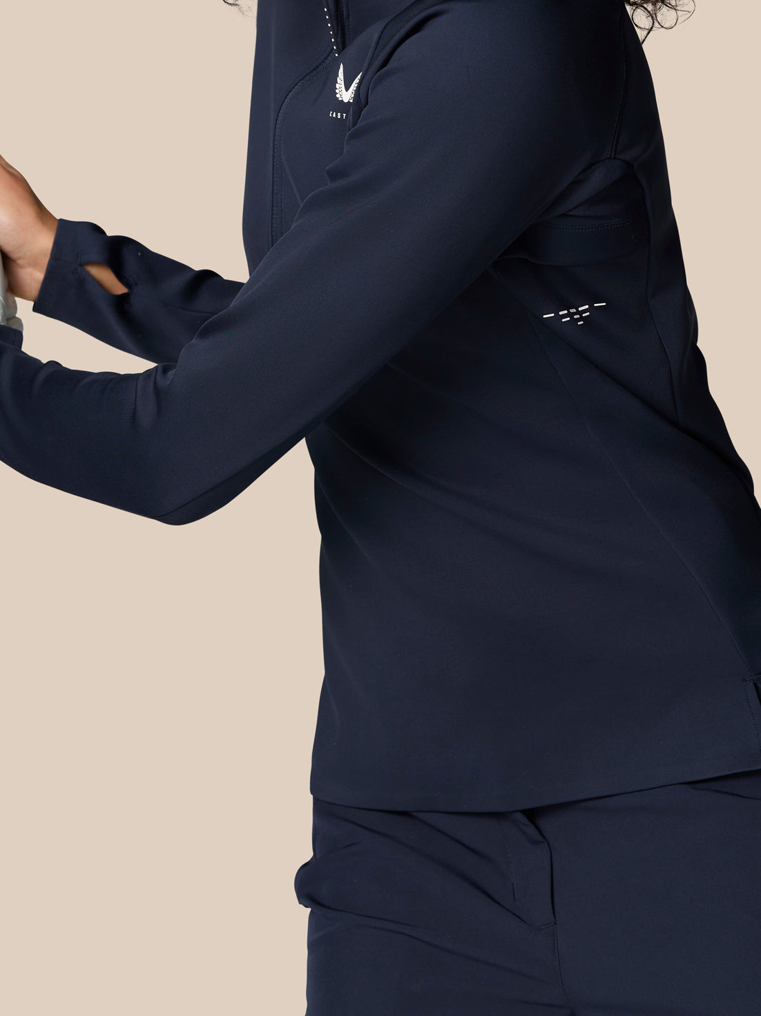Side view of navy Pinnacle LVS half zip top showing side vents and chest logo