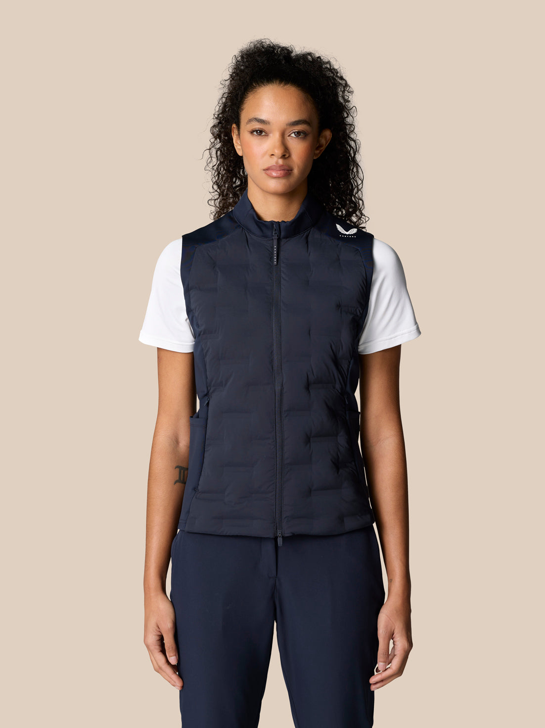 Model wearing navy Pinnacle Hybrid Gilet with white T shirt, front view