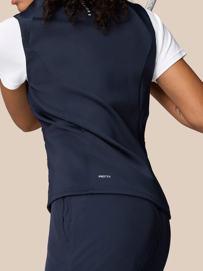 Close up of back and side of navy Pinnacle Hybrid Gilet showing ProTek branding at hem