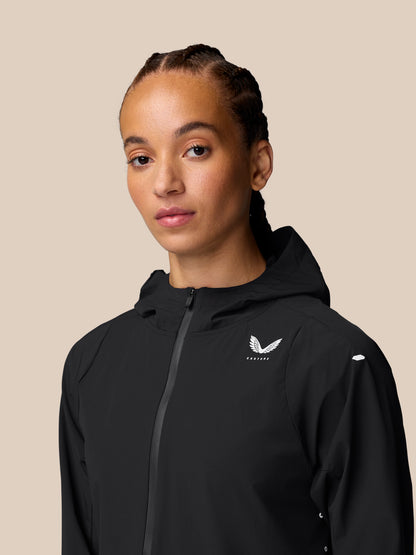 Model wearing black Apex Training Wind Jacket with hood and front zipper.