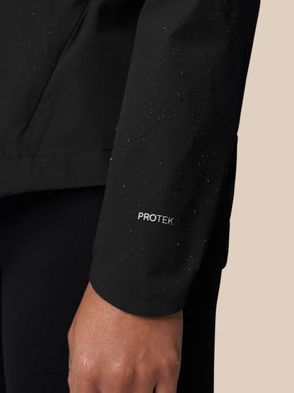 Water droplets on the PROTEK weather resistant sleeve of the black Apex Wind Jacket.
