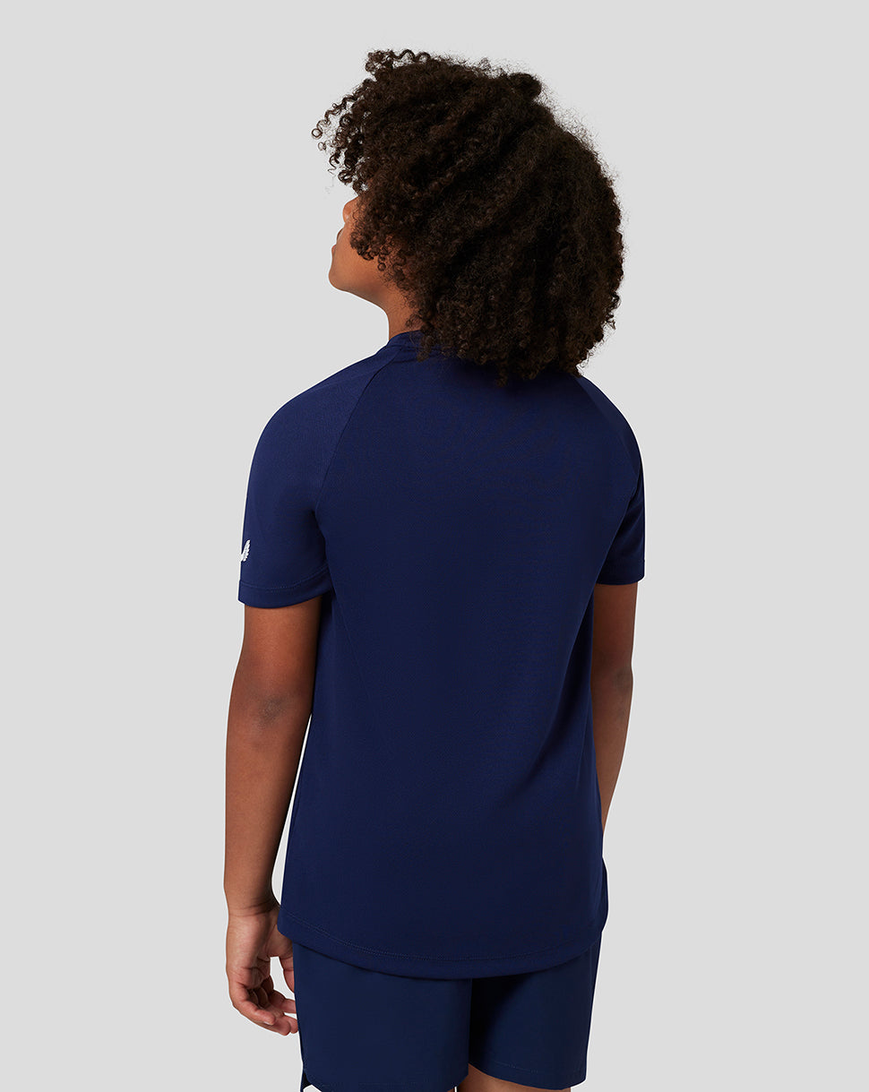 Back view of a child wearing navy Castore short sleeve raglan T shirt