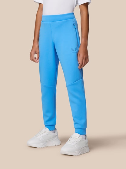 Close-up of blue Flex Scuba trousers at the hip with a side zip pocket and Castore logo, worn with white sneakers