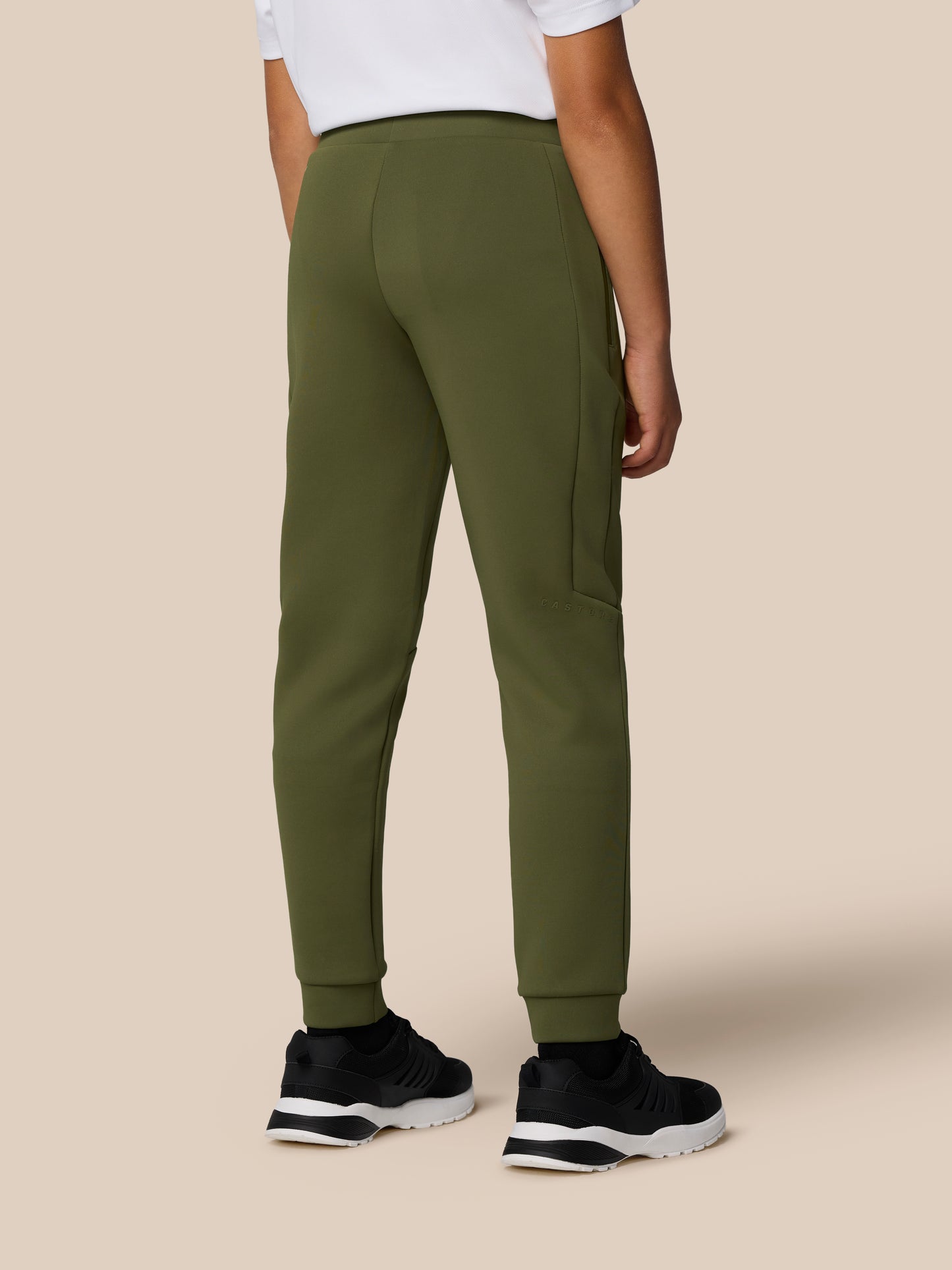 Back view of olive green Junior's Flex Scuba Trousers Unisex with a side zip pocket and Castore logo on the leg.