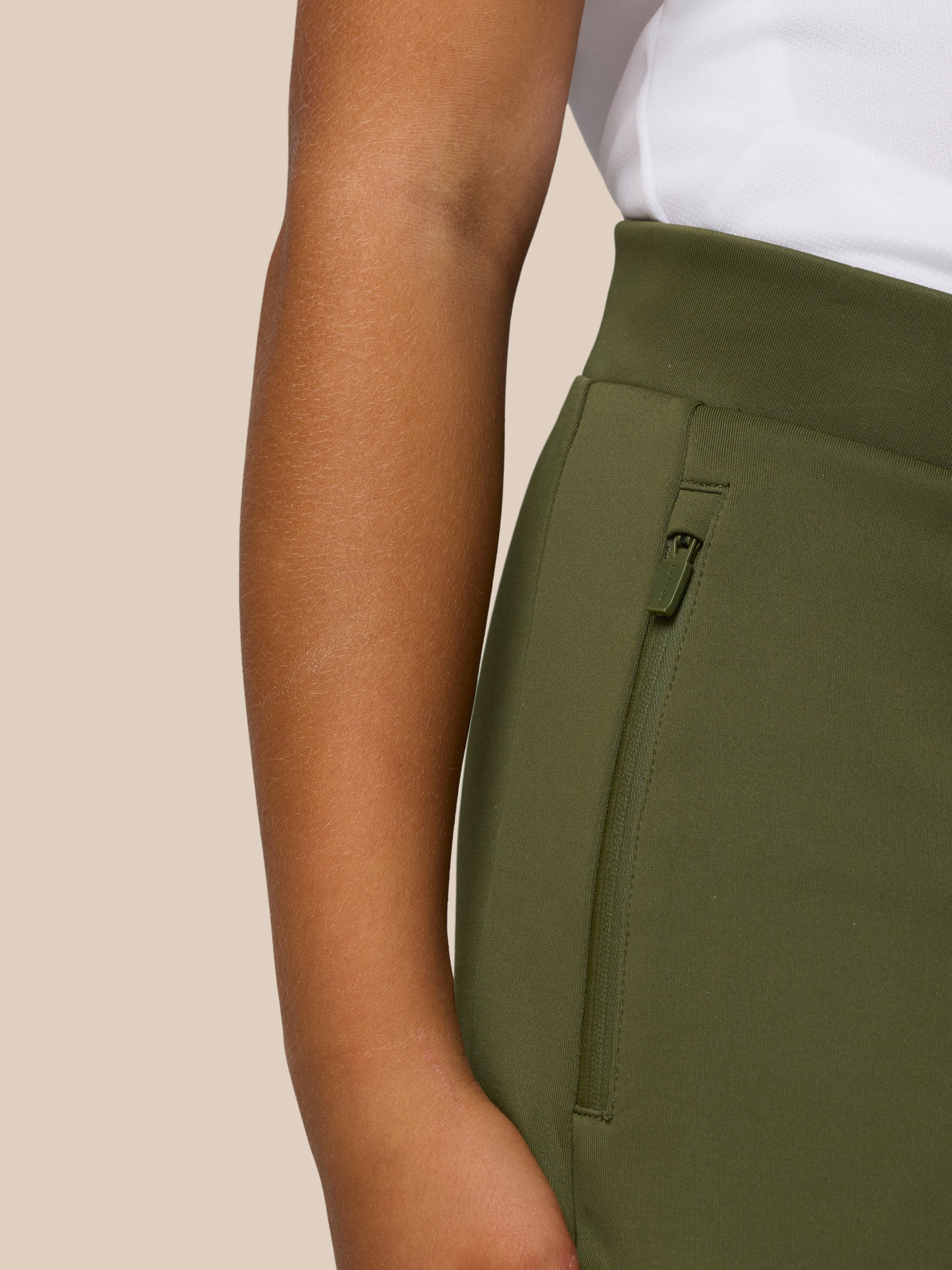 Close up of olive green junior scuba trousers showing a side zip pocket and durable fabric