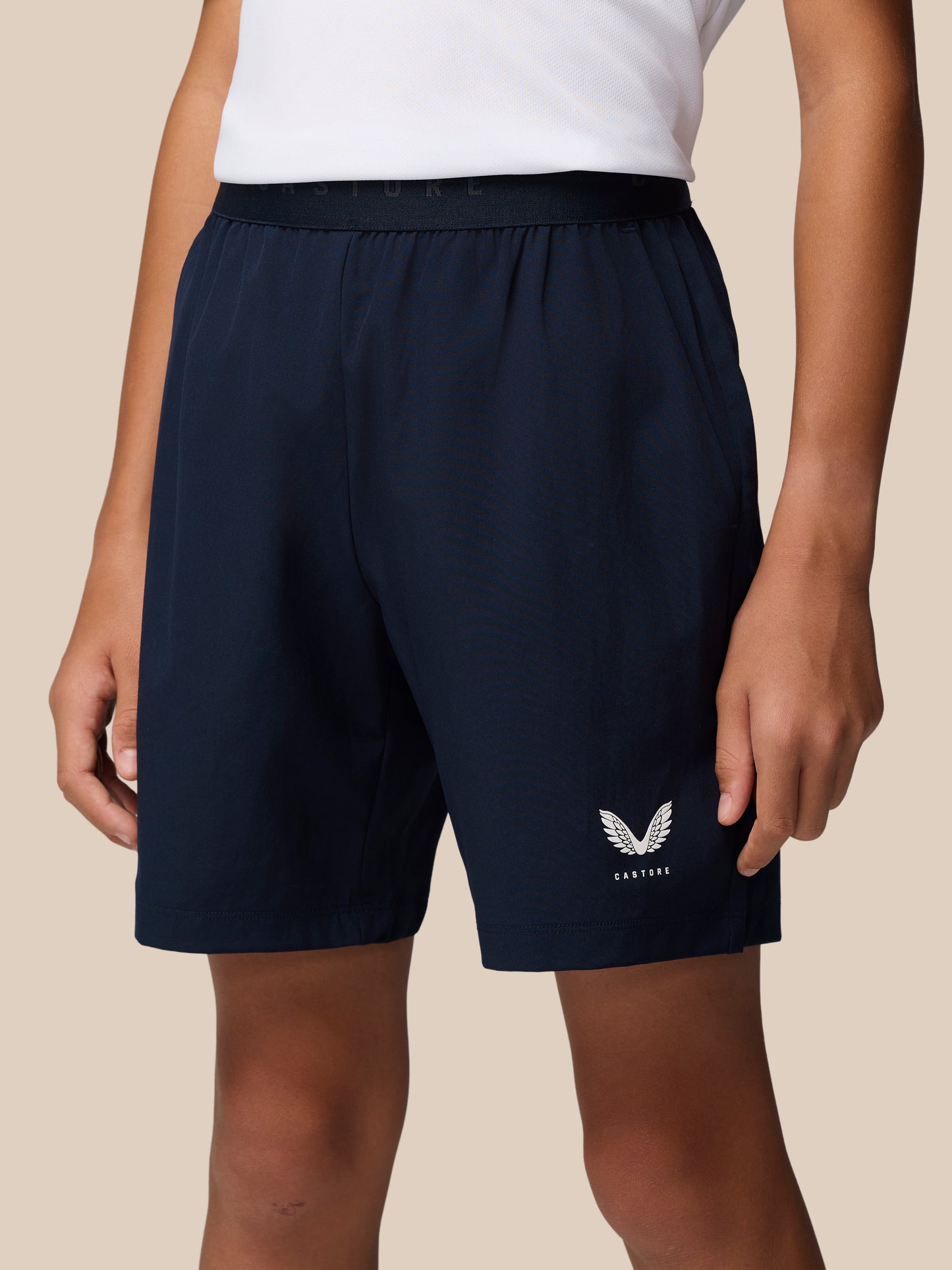 Navy junior woven shorts with an elastic waistband and Castore logo on the thigh