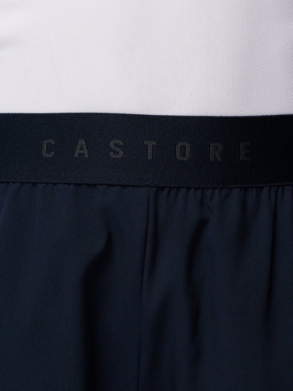Close up of navy Junior’s Adapt Woven Shorts waistband showing a black elastic band with Castore branding.
