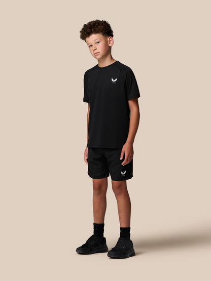 Boy wearing black Junior Adapt Short Sleeve T Shirt with Castore logo on the left chest