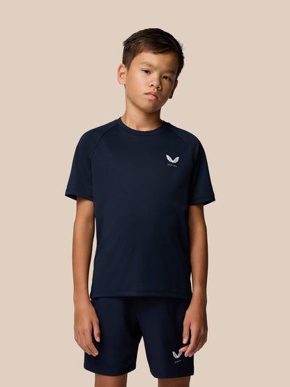 Side profile of a boy in navy Adapt Short Sleeve T Shirt with small Castore logo on the left chest.