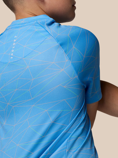 Close-up of a blue geometric print junior short sleeve T shirt with visible shoulder seam and back neck.