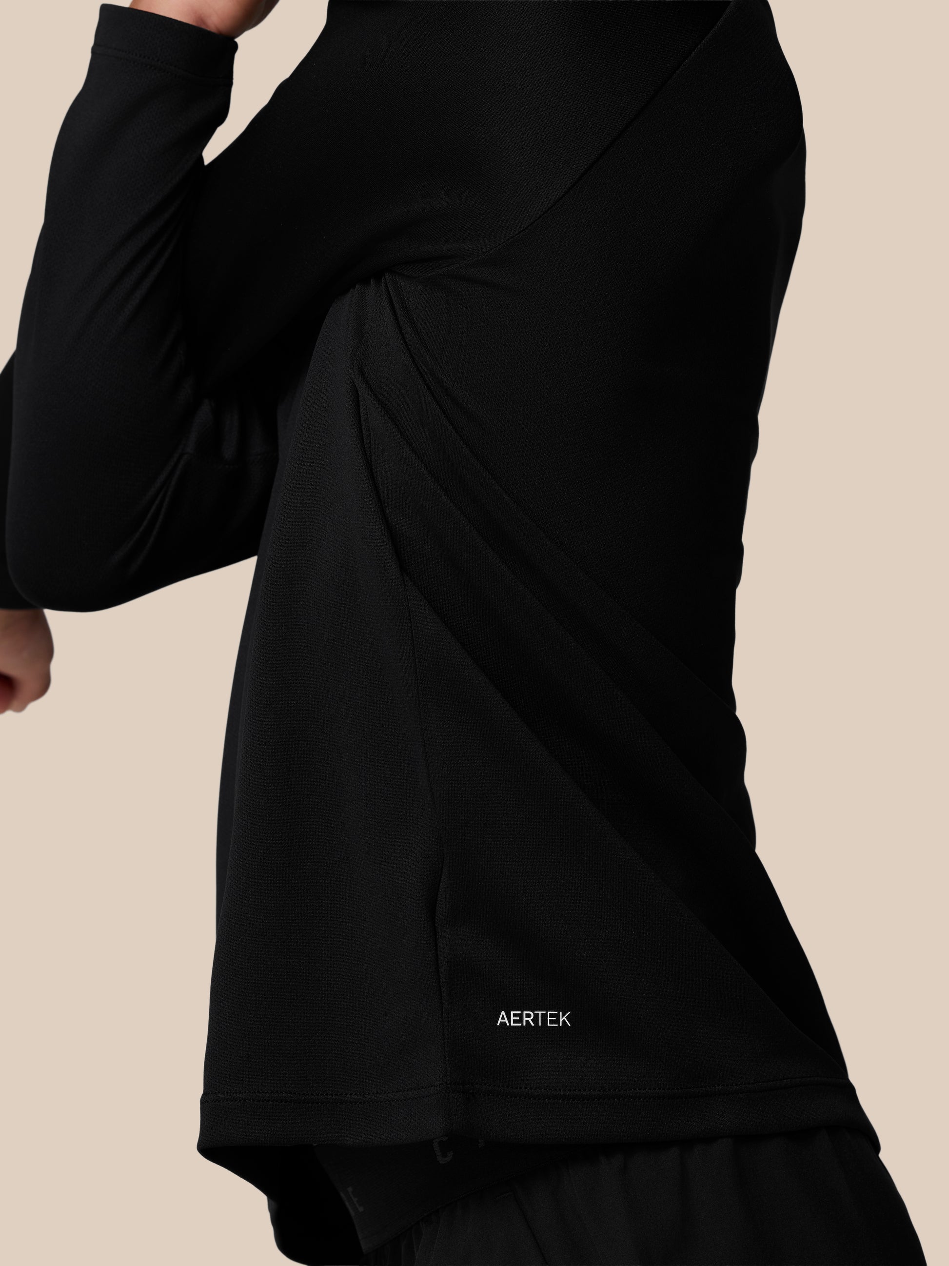 Back view of the black Adapt lightweight quarter zip showing branded back neck tape and collar details.