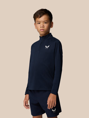 Young model wearing navy Junior Adapt Lightweight Quarter Zip with logo on chest.