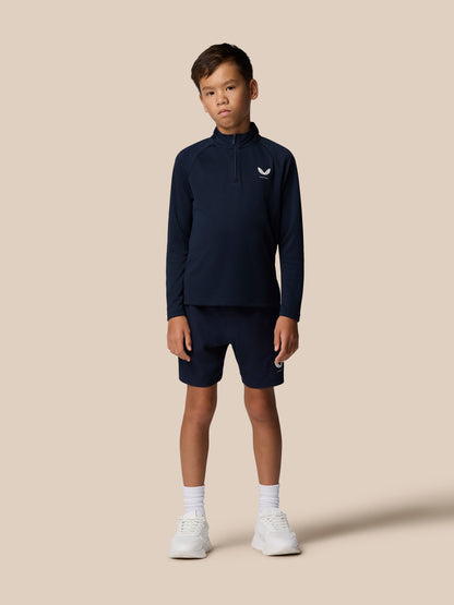 Full-body front view of a young boy in navy Adapt Lightweight Quarter Zip with matching navy shorts