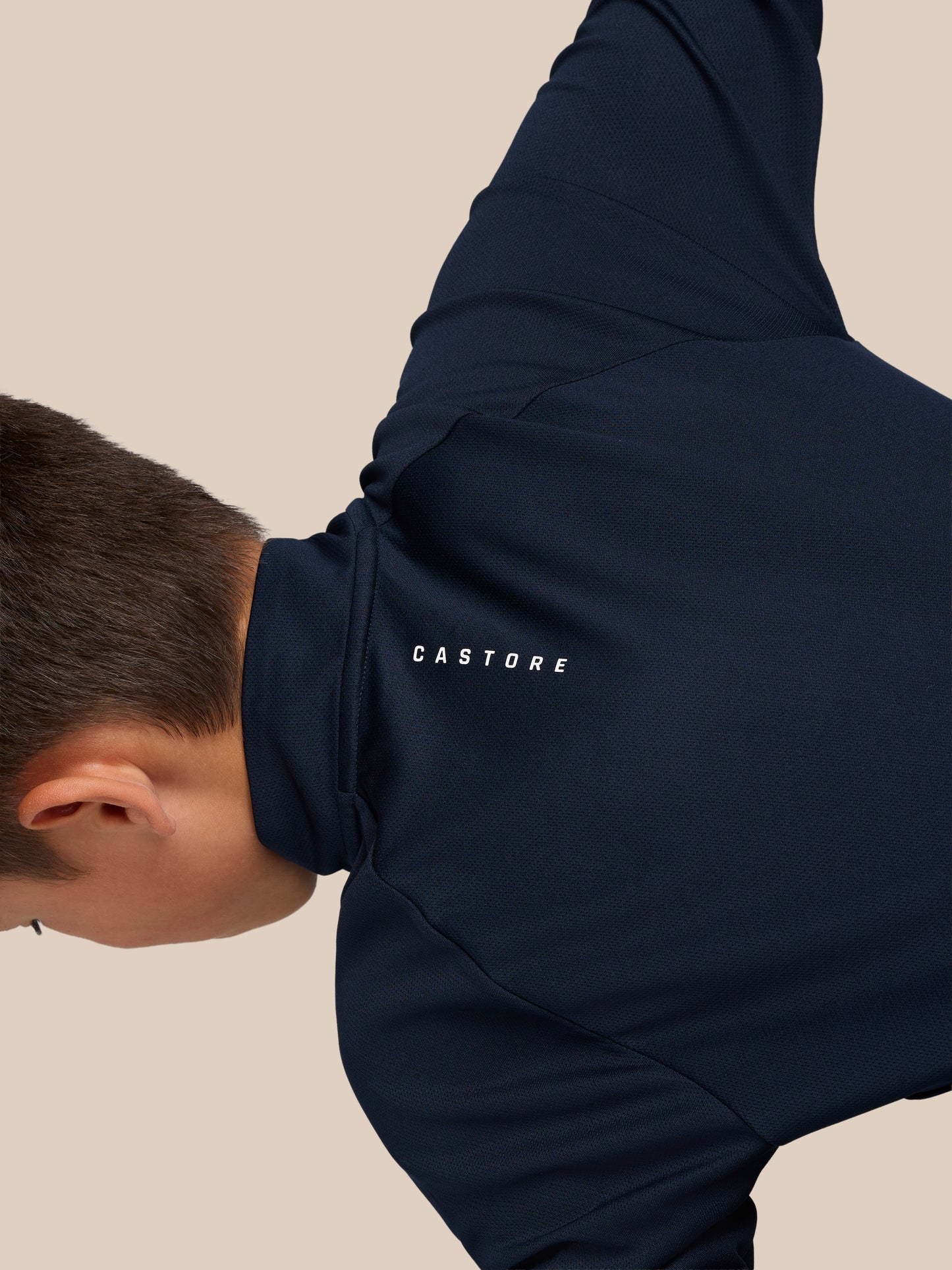 Navy junior Castore Adapt lightweight quarter-zip hoodie with hood, showing back neck branding