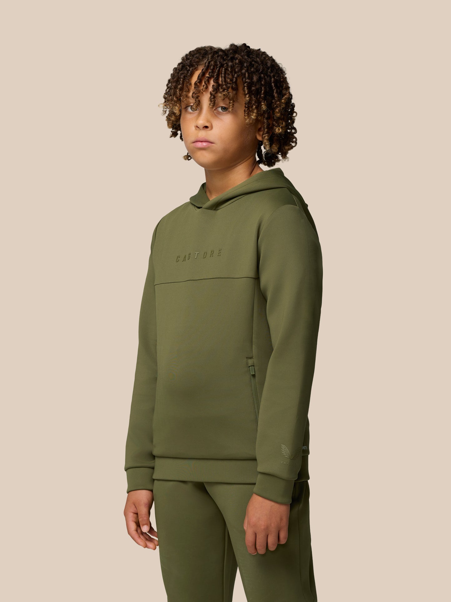 Young model wearing green Flex Scuba hoodie with Castore branding across the chest