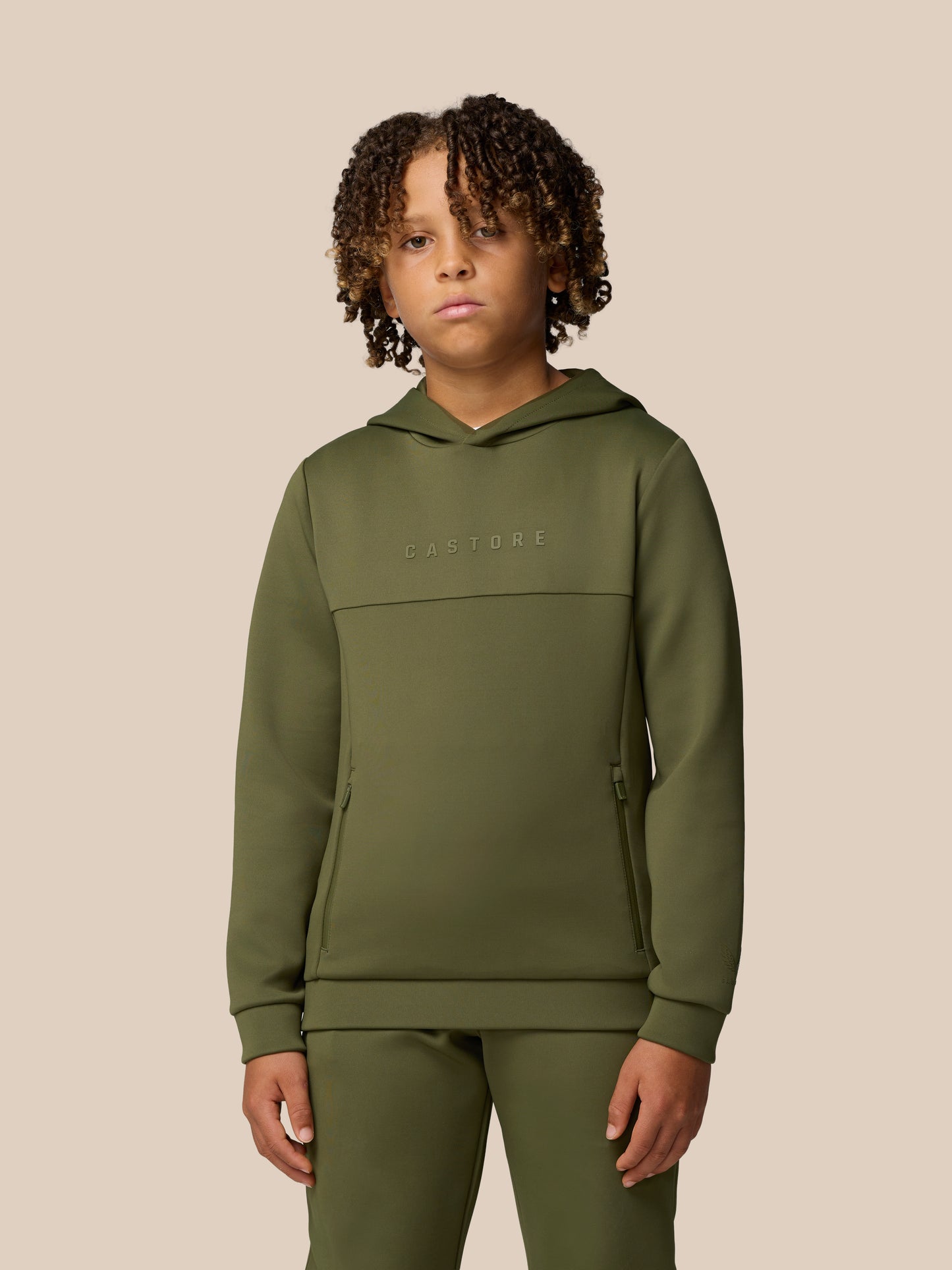 Green Junior Flex Scuba hoodie worn by a child with Castore wordmark on the chest and logo on the sleeve