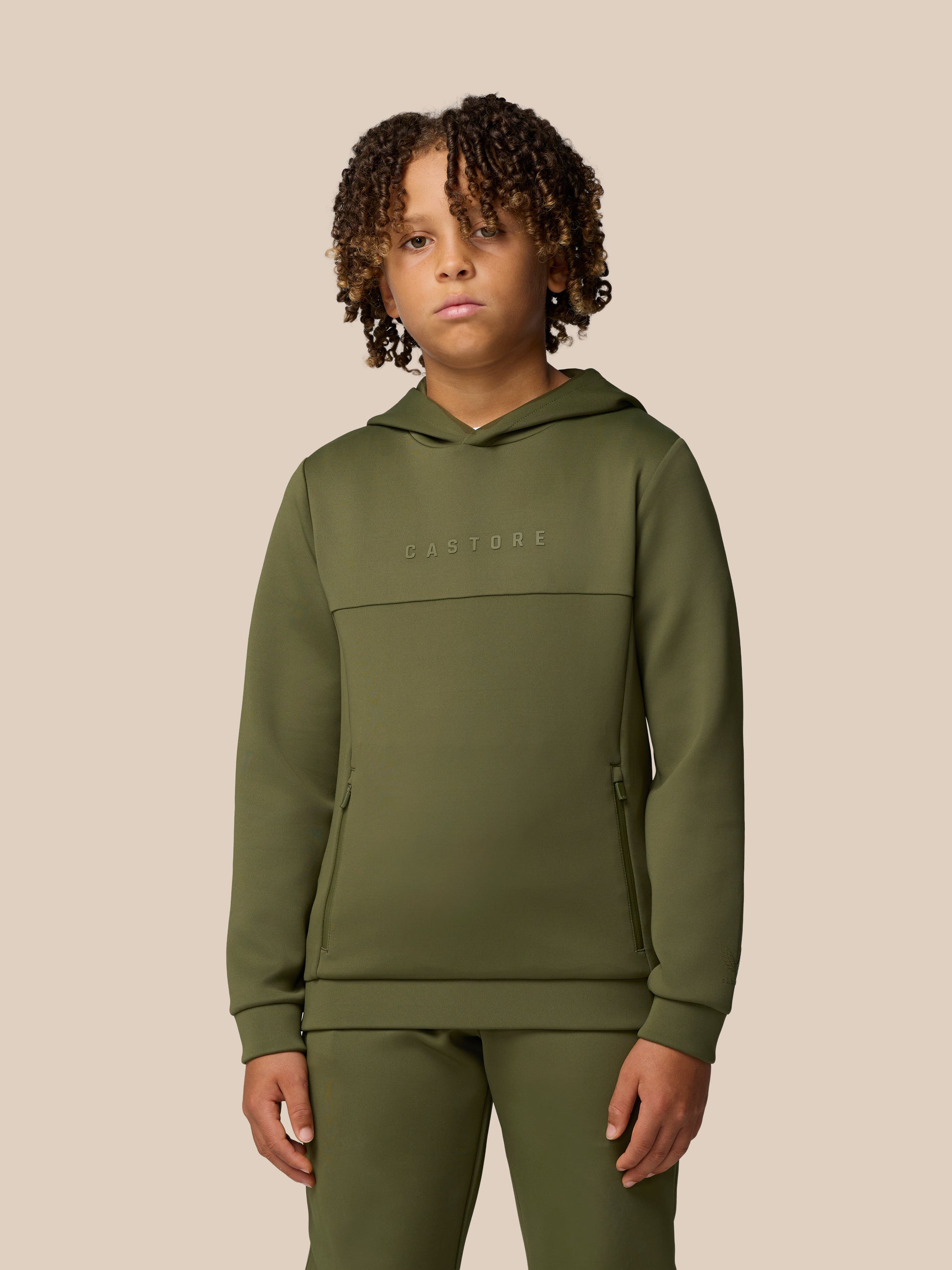 Green Junior Flex Scuba hoodie worn by a child with Castore wordmark on the chest and logo on the sleeve