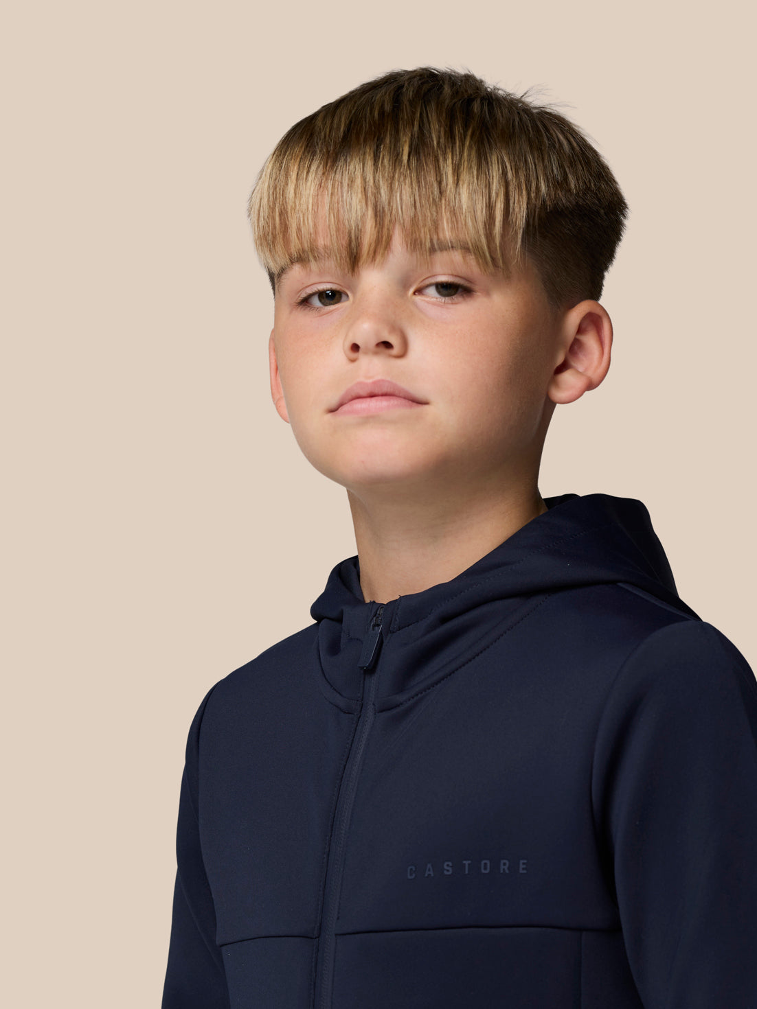 Front view of a young boy wearing navy Junior's Flex Scuba full zip jacket