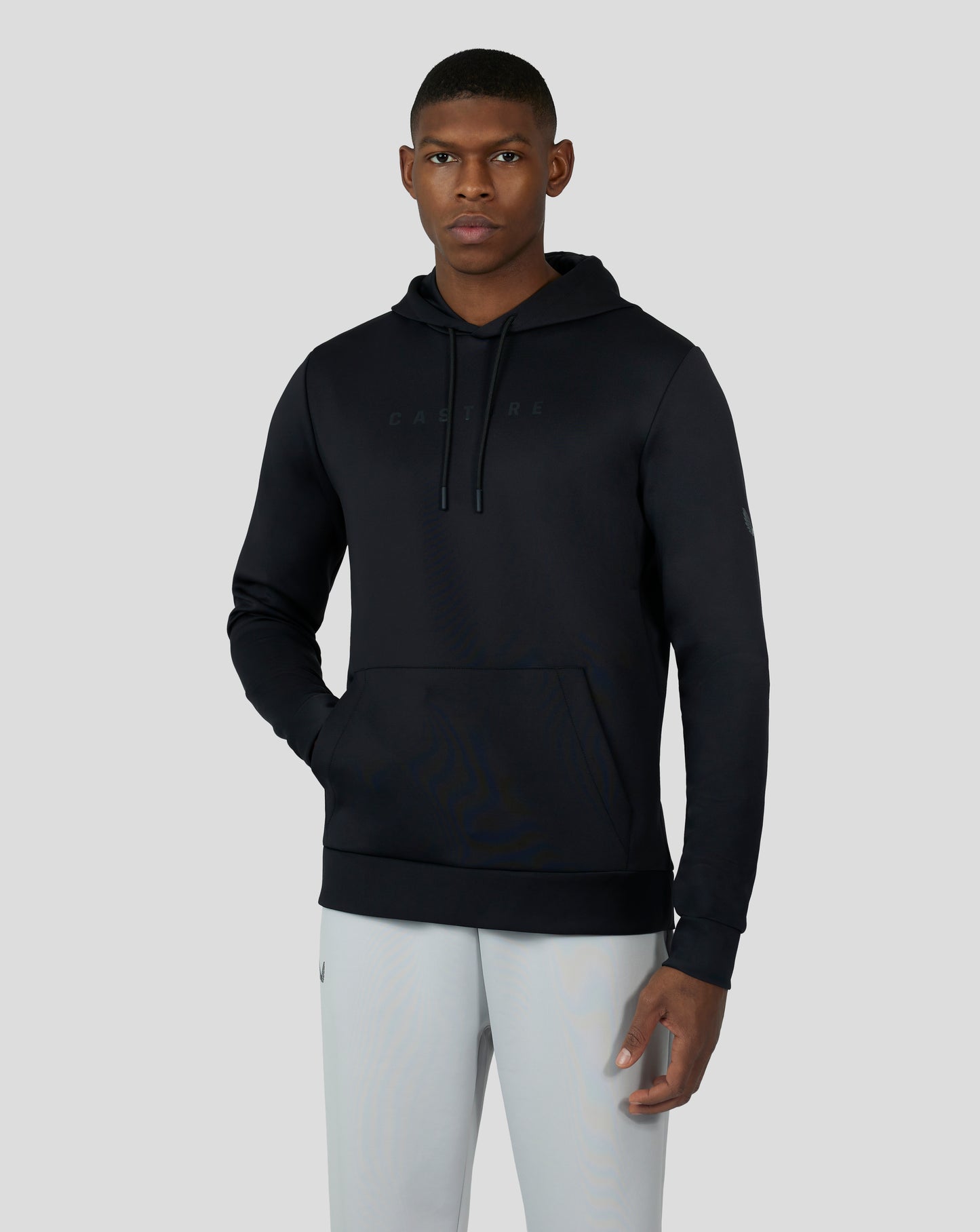 Male model wearing black Flex Hoodie 3.0 with hood and subtle chest branding