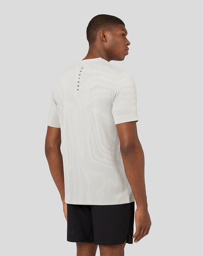 Back view of Oyster white Core Tech T Shirt with subtle pattern and vertical branding down the spine.