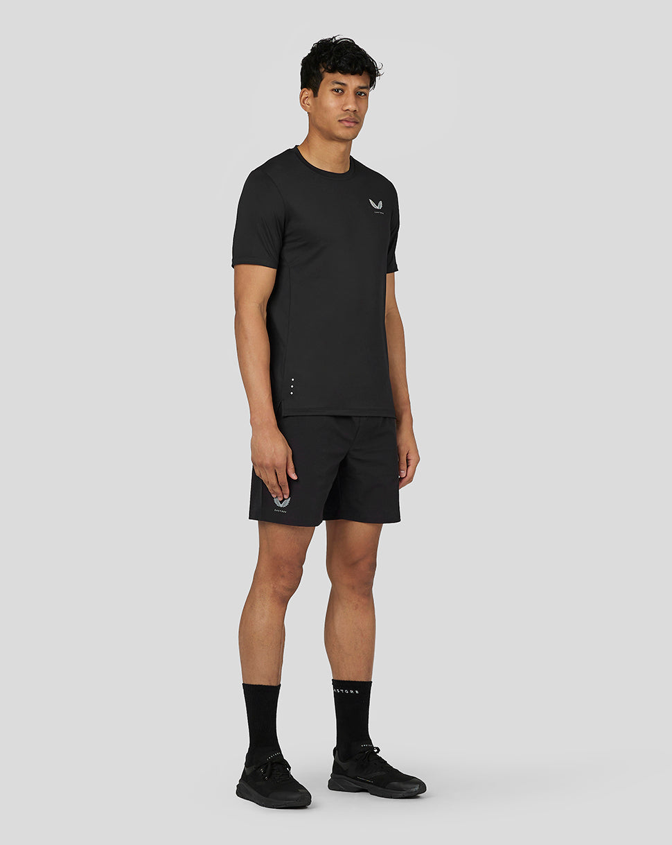 Male model wearing black active woven shorts and matching top, Castore branding visible on the shorts.
