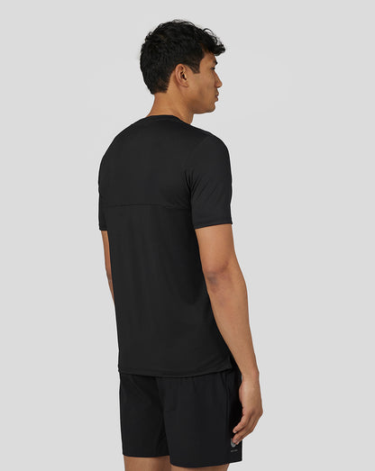 Back view of a man in black Castore performance short sleeve tee highlighting mesh back panel