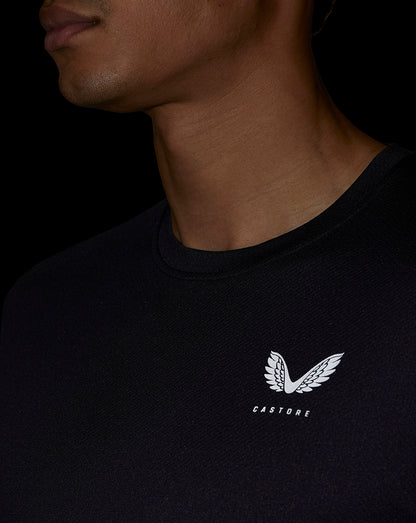 Male model wearing black short-sleeve performance T shirt with small white logo on the left chest